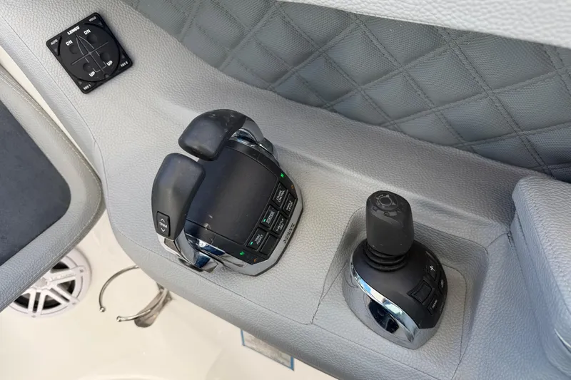 Slide: The Image of 2019 Cobalt R35 boat controls with joystick and throttle on gray panel. - 36