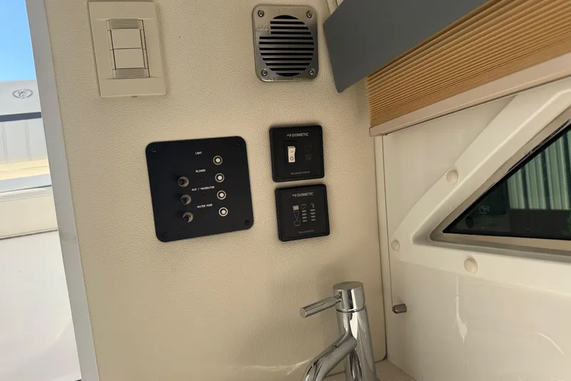 Slide: The Image of Control panel and faucet inside a 2019 Cobalt R35 boat cabin. - 39