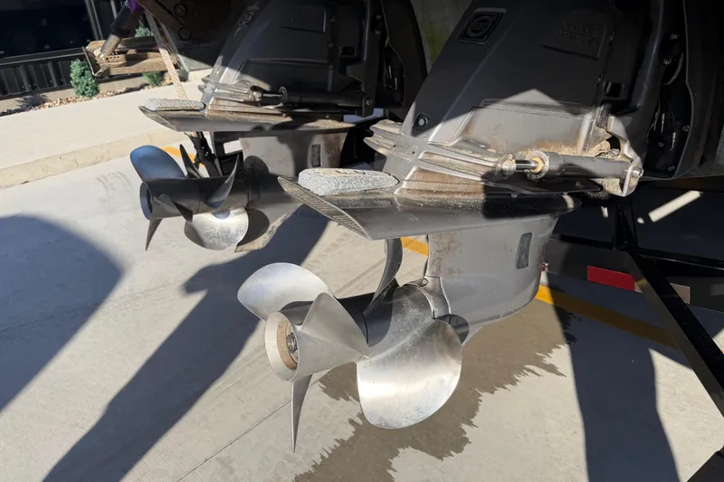 Slide: The Image of Dual propellers on a 2019 Cobalt R35 boat, parked on concrete. - 48