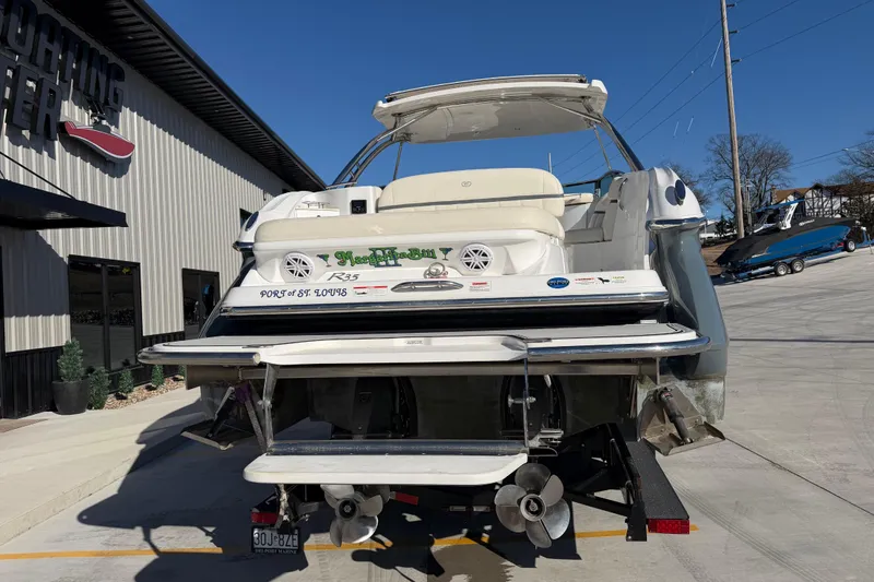 Slide: The Image of 2019 Cobalt R35 boat at a marina, rear view with propellers visible. - 5