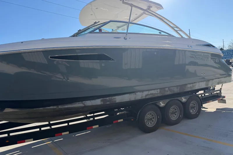 Slide: The Image of 2019 Cobalt R35 boat on trailer under clear blue sky. - 9