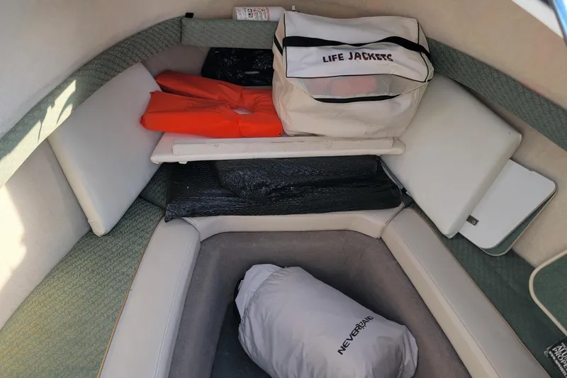 Slide: The Image of Interior of a 2003 Trophy 2002 Walkaround boat with life jackets and storage. - 11