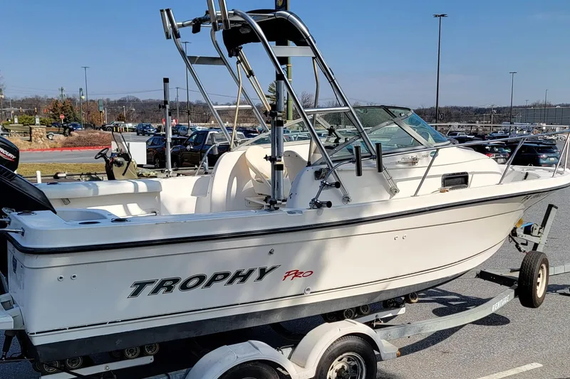 Slide: The Image of 2003 Trophy 2002 Walkaround boat on trailer in parking lot. - 5