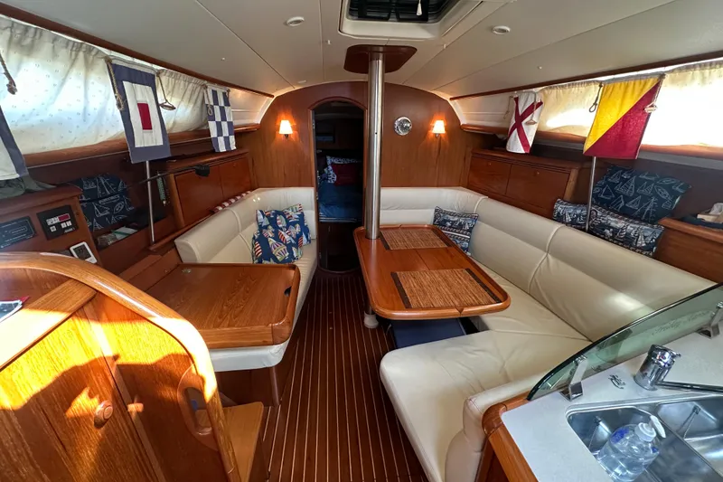 Slide: The Image of Interior of 2004 Jeanneau Sun Odyssey 35 sailboat with cozy seating and nautical decor. - 10