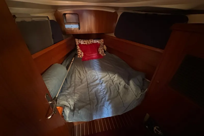 Slide: The Image of Cozy cabin interior of 2004 Jeanneau Sun Odyssey 35 sailboat with bed and pillows. - 13