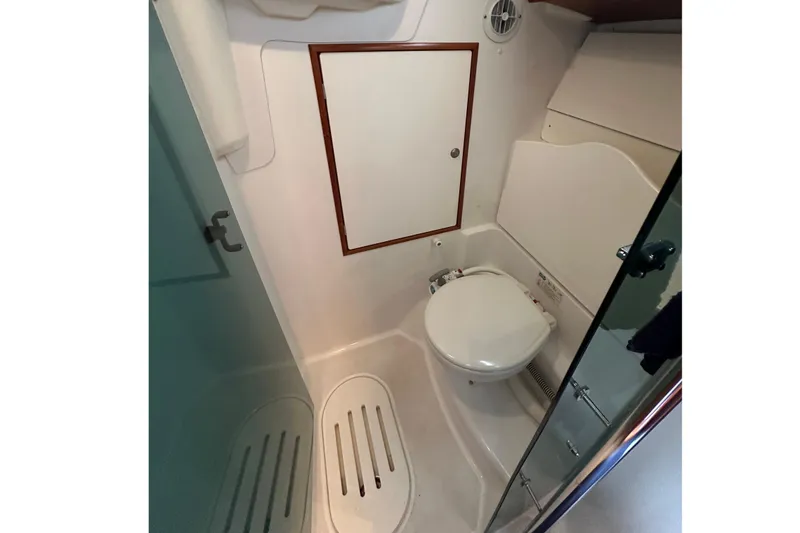 Slide: The Image of Compact bathroom in 2004 Jeanneau Sun Odyssey 35 sailboat, featuring a toilet and shower area. - 16