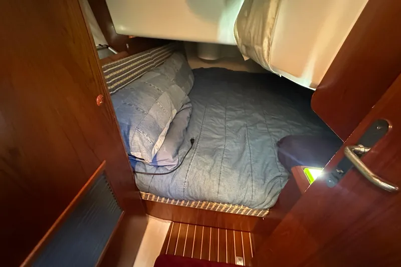 Slide: The Image of Cozy cabin interior of 2004 Jeanneau Sun Odyssey 35 sailboat with wooden finish. - 18