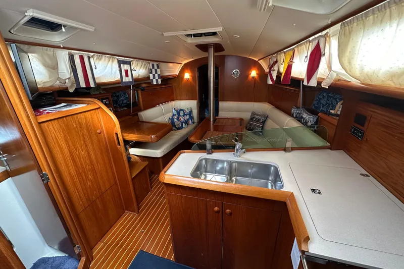 Slide: The Image of Interior of 2004 Jeanneau Sun Odyssey 35 sailboat with cozy seating and kitchen area. - 20