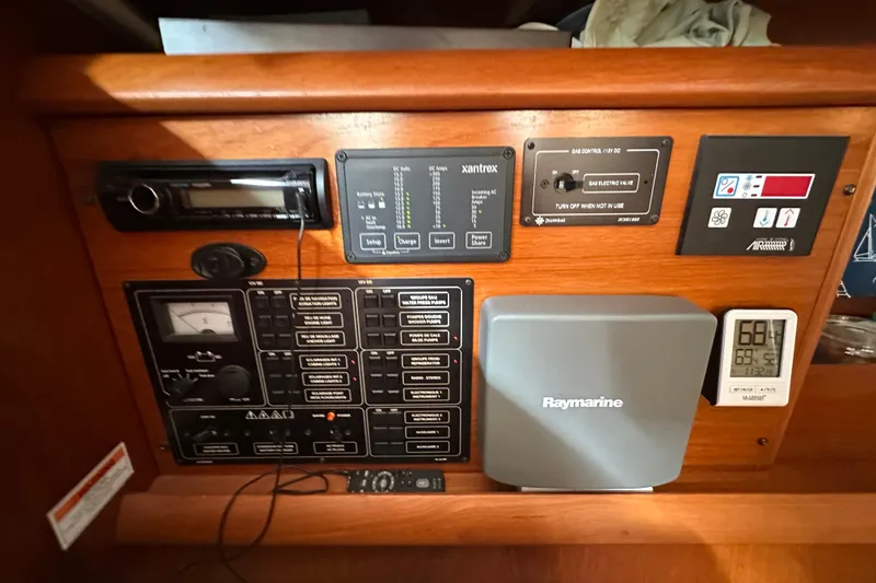 Slide: The Image of Control panel of a 2004 Jeanneau Sun Odyssey 35 sailboat with navigation and monitoring equipment. - 24