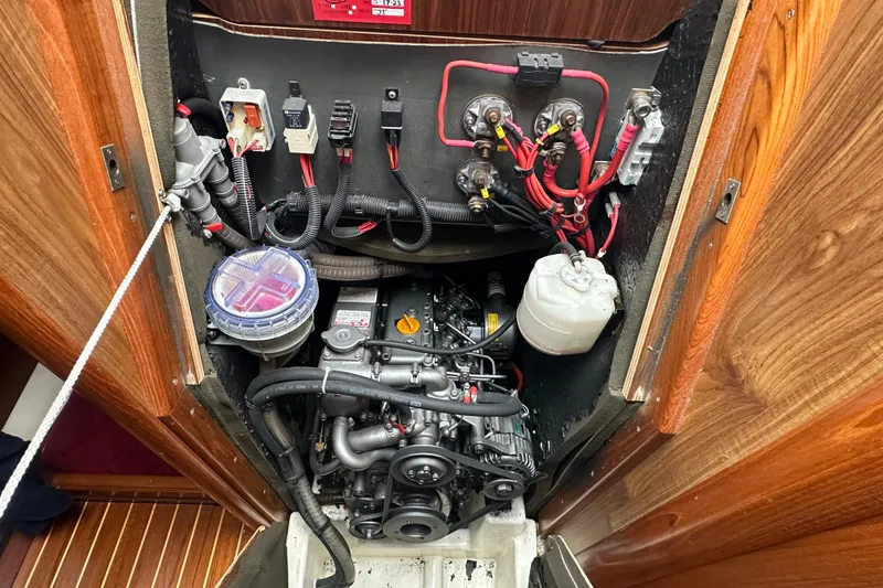 Slide: The Image of Engine compartment of 2004 Jeanneau Sun Odyssey 35 sailboat, showcasing wiring and components. - 26