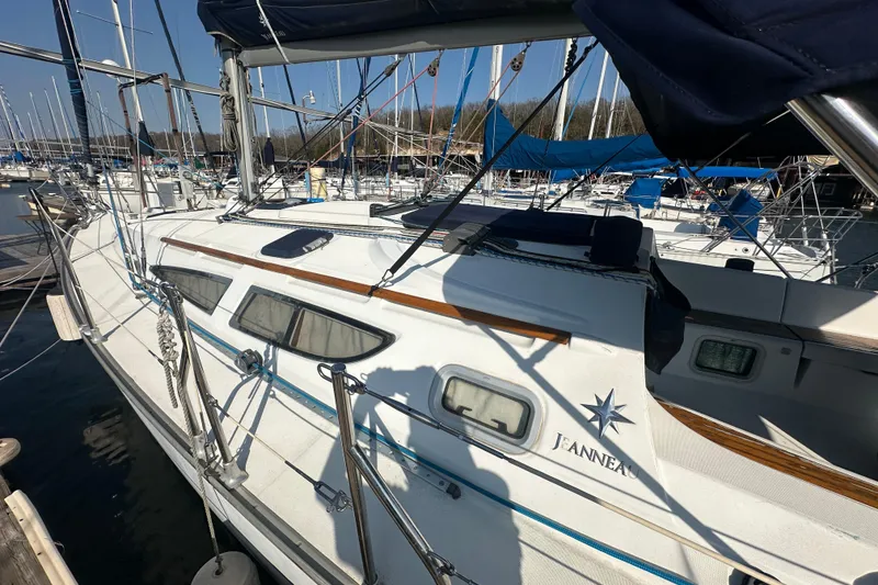 Slide: The Image of 2004 Jeanneau Sun Odyssey 35 sailboat docked in marina, side view. - 3