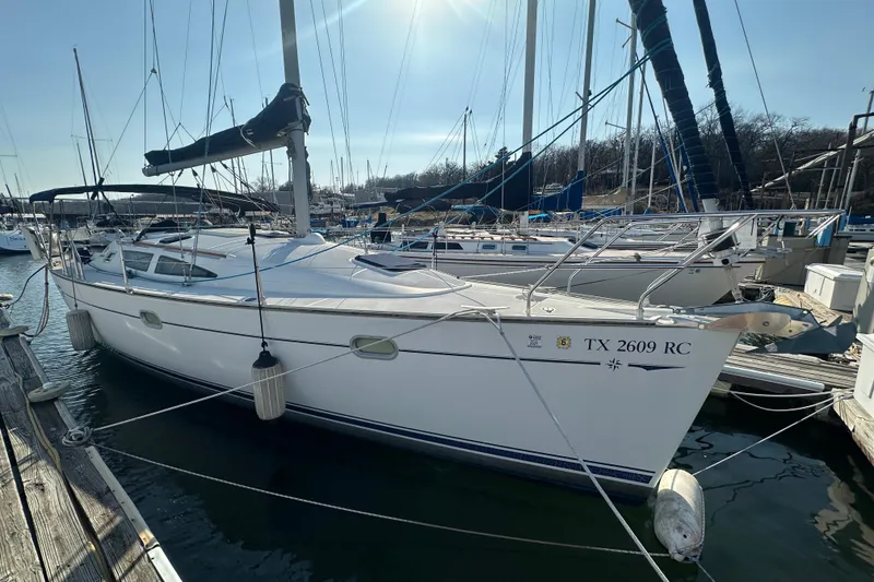 Slide: The Image of 2004 Jeanneau Sun Odyssey 35 sailboat docked at marina under clear sky. - 4