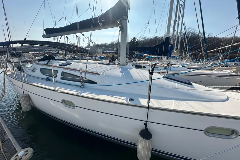 Slide: The Image of 2004 Jeanneau Sun Odyssey 35 sailboat docked in a marina, side view. - 5