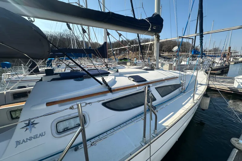 Slide: The Image of 2004 Jeanneau Sun Odyssey 35 sailboat docked at marina, clear sky background. - 8