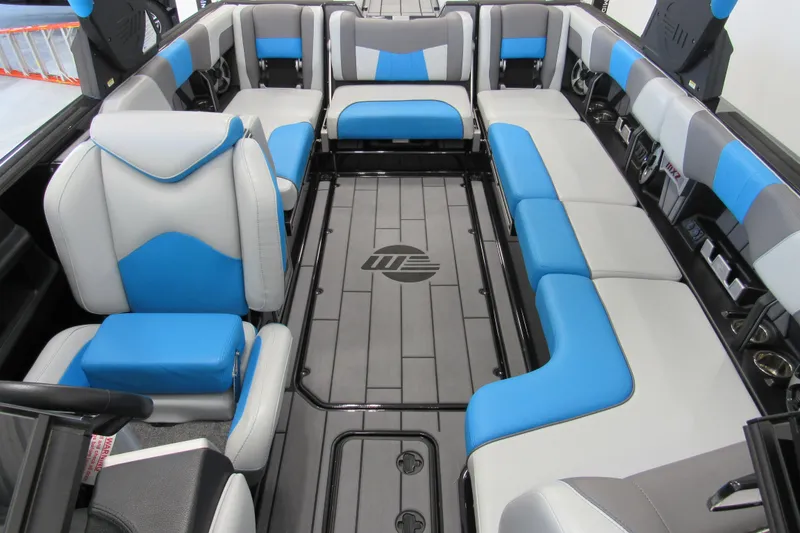 Slide: The Image of 2021 Malibu Wakesetter 24 MXZ interior with blue and gray seating arrangement. - 12