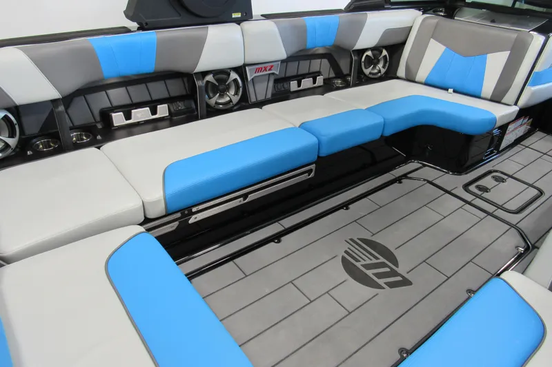 Slide: The Image of 2021 Malibu Wakesetter 24 MXZ interior with blue and gray seating, premium audio system. - 4