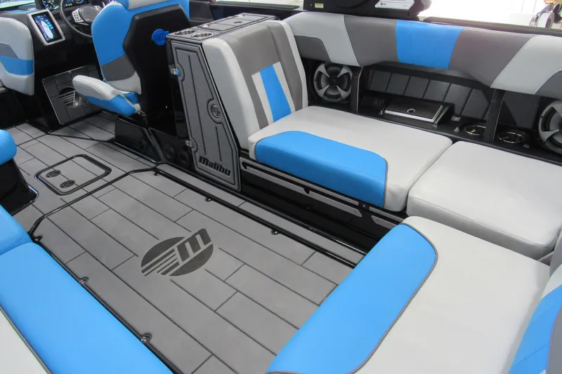 Slide: The Image of 2021 Malibu Wakesetter 24 MXZ interior with blue and gray seating, modern design. - 5