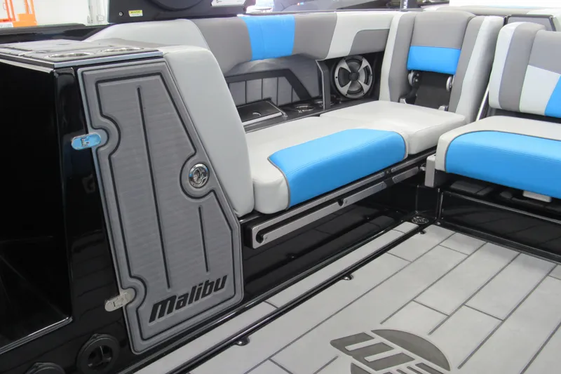 Slide: The Image of 2021 Malibu Wakesetter 24 MXZ interior with blue and gray seating, sleek design. - 6