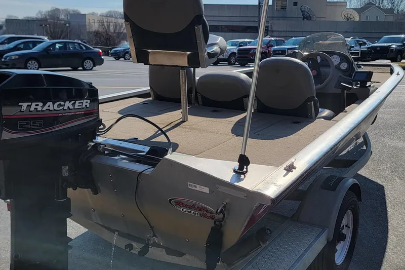 Slide: The Image of 2003 Tracker Pro Team 175 boat with Mercury 25 outboard motor in parking lot. - 3