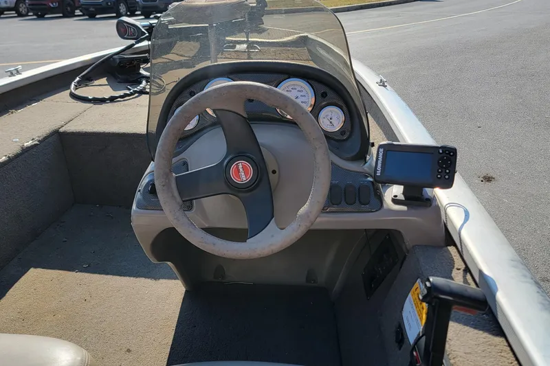 Slide: The Image of 2003 Tracker Pro Team 175 boat dashboard with steering wheel and navigation equipment. - 5