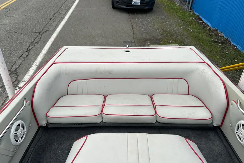 Slide: The Image of 1988 Supra Comp boat interior with white and red cushioned seating. - 13