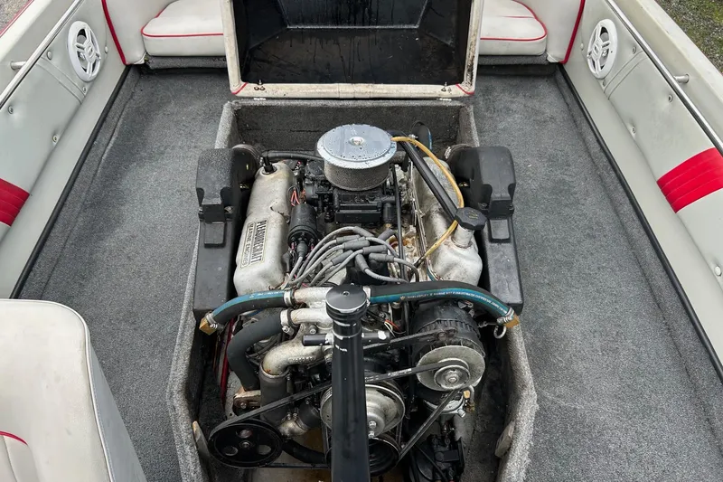 Slide: The Image of 1988 Supra Comp boat engine compartment with visible engine components and interior seating. - 14