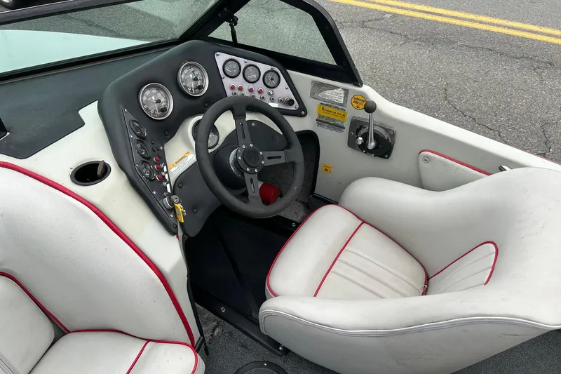 Slide: The Image of 1988 Supra Comp boat interior with steering wheel, gauges, and white seats. - 5