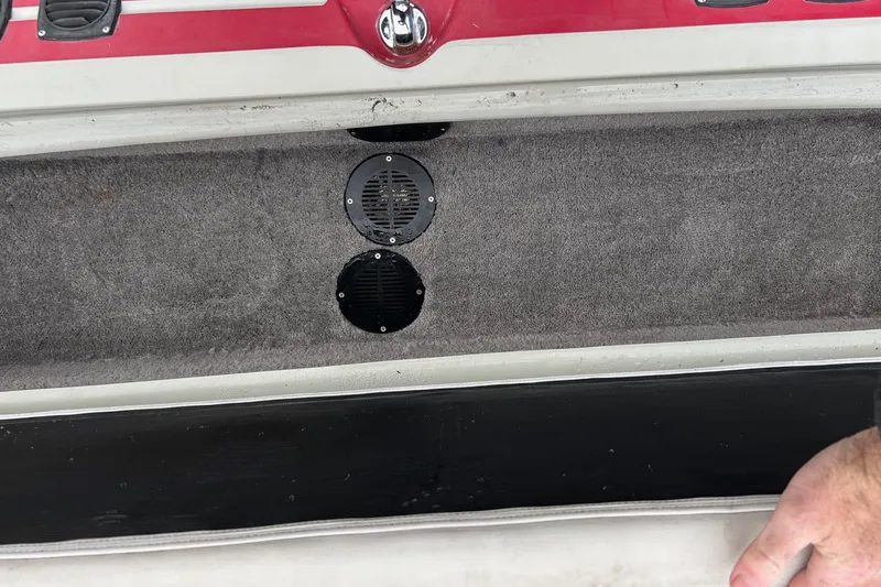 Slide: The Image of 1988 Supra Comp boat interior with carpeted storage and speaker vents. - 7