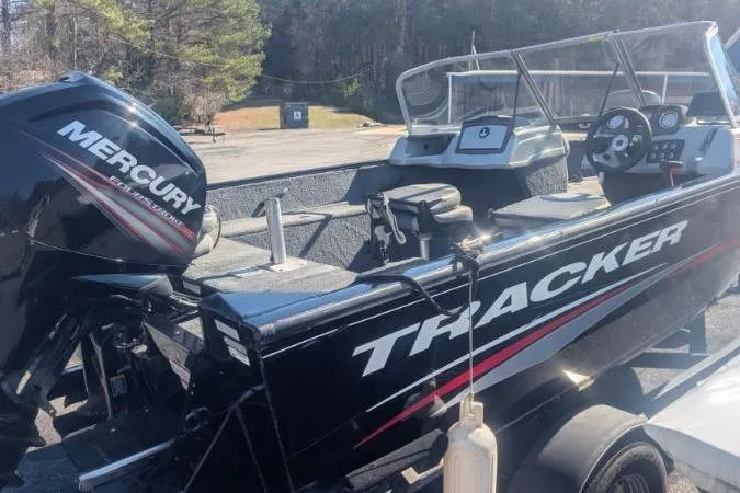 Slide: The Image of 2017 Tracker Pro Guide V-175 Combo boat with Mercury engine, parked outdoors. - 12