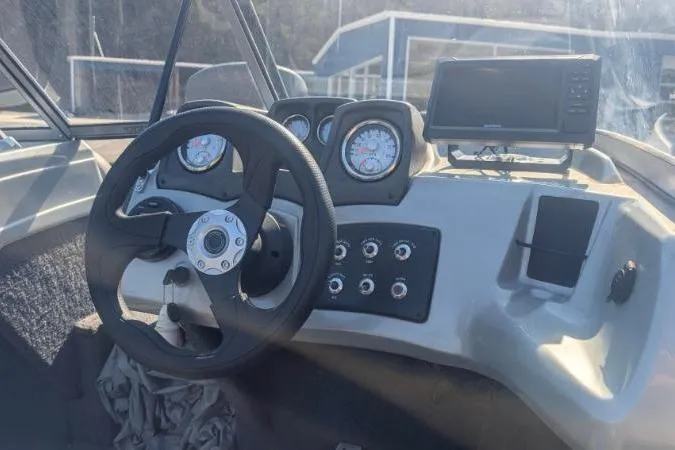 Slide: The Image of 2017 Tracker Pro Guide V-175 Combo boat dashboard with steering wheel and gauges. - 2