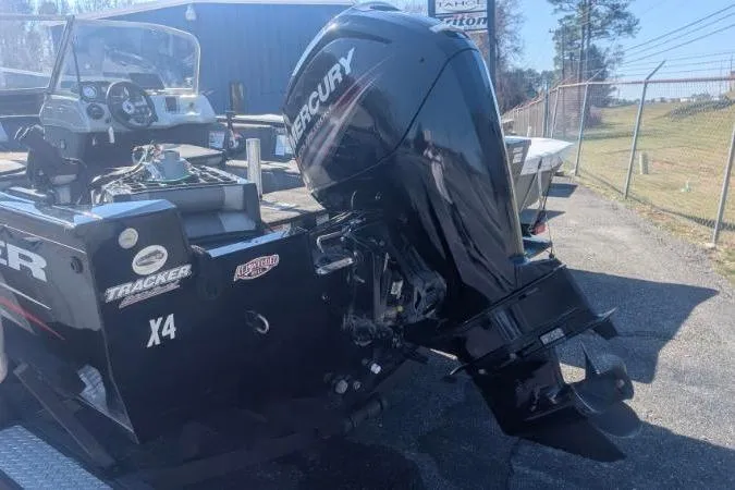 Slide: The Image of 2017 Tracker Pro Guide V-175 Combo boat with Mercury outboard motor, parked outdoors. - 9