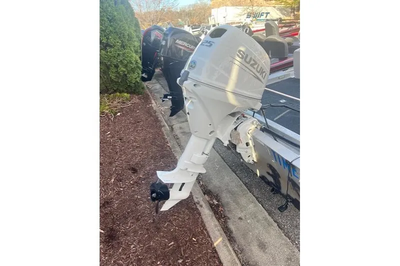 Slide: The Image of White Suzuki outboard motor attached to a Grumman Outlaw boat, 1985 model. - 4