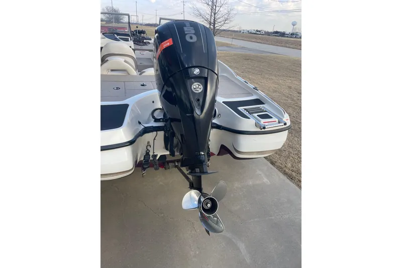 Slide: The Image of 2016 Nitro Z-7 Sport boat with an outboard motor, parked on concrete. - 10