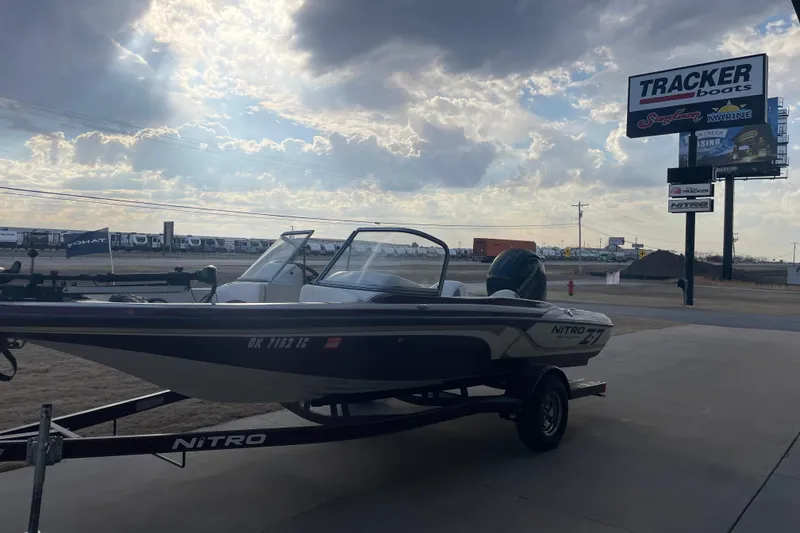 Slide: The Image of 2016 Nitro Z-7 Sport boat on trailer at dealership under cloudy sky. - 2