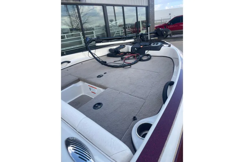 Slide: The Image of 2016 Nitro Z-7 Sport boat interior with carpeted deck and fishing equipment. - 4