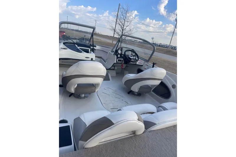 Slide: The Image of 2016 Nitro Z-7 Sport boat interior with white seating and steering console. - 7