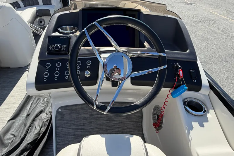 Slide: The Image of 2021 Bennington QX 25 QXFBA boat dashboard with steering wheel and controls. - 12