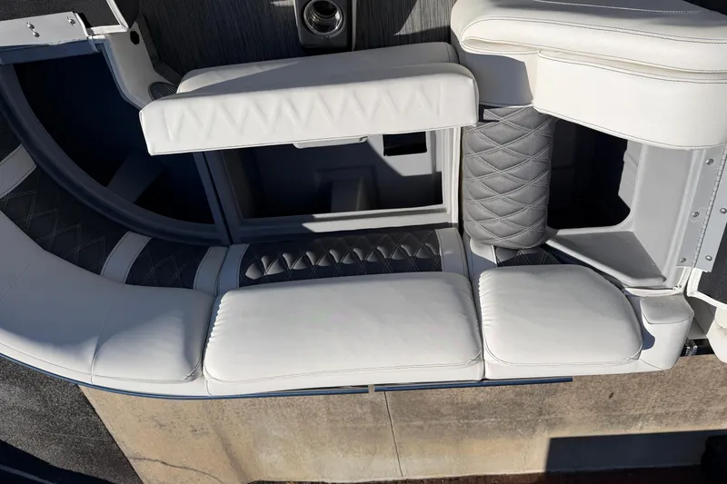 Slide: The Image of Luxurious seating on a 2021 Bennington QX 25 QXFBA pontoon boat, featuring white and gray upholstery. - 19