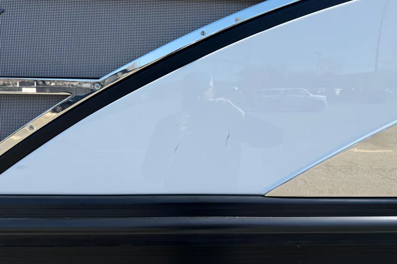 Slide: The Image of 2021 Bennington QX 25 QXFBA boat exterior with sleek design and reflective surface. - 4