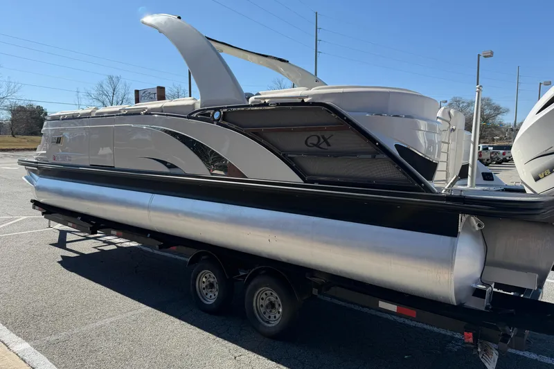 Slide: The Image of 2021 Bennington QX 25 QXFBA pontoon boat on trailer in parking lot. - 9