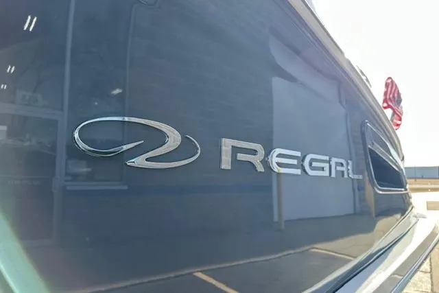 Slide: The Image of 2023 Regal 2800 Bowrider boat, close-up of logo on sleek exterior. - 11