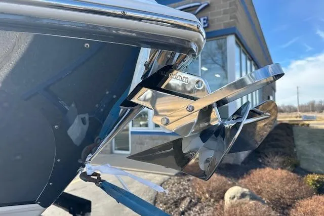 Slide: The Image of 2023 Regal 2800 Bowrider boat with shiny stainless steel propeller detail. - 12