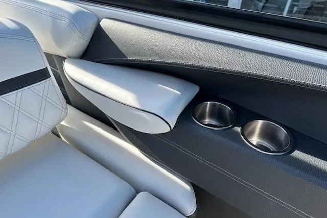 Slide: The Image of 2023 Regal 2800 Bowrider interior with white leather seats and dual cup holders. - 22