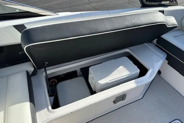 Slide: The Image of 2023 Regal 2800 Bowrider boat with open storage compartment and cooler. - 25