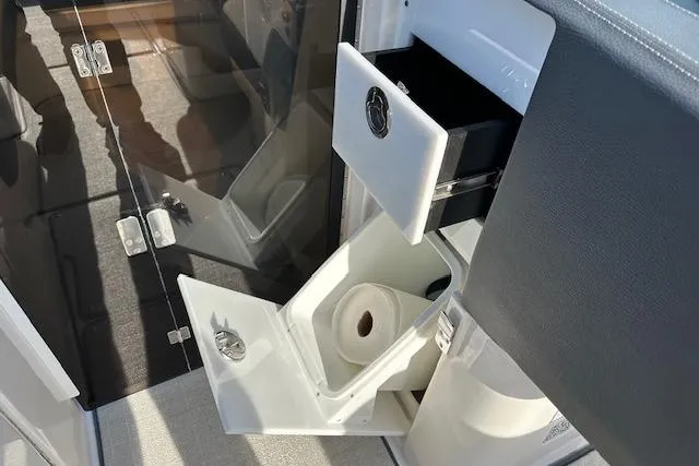 Slide: The Image of 2023 Regal 2800 Bowrider interior storage with toilet paper holder and drawer. - 28