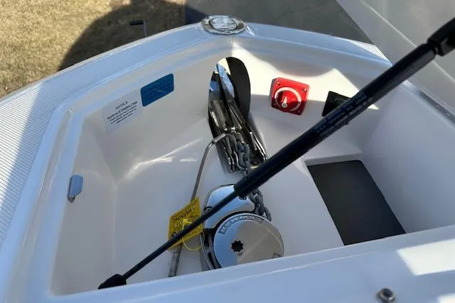 Slide: The Image of 2023 Regal 2800 Bowrider anchor compartment with chain and hydraulic support. - 33