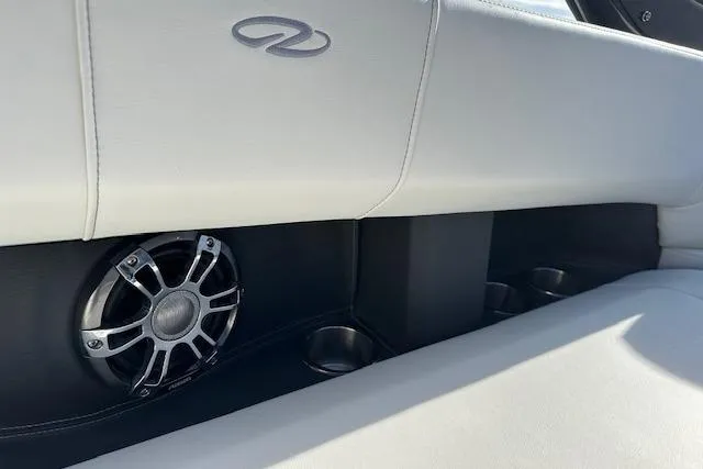 Slide: The Image of 2023 Regal 2800 Bowrider interior with speaker and cup holders, featuring sleek white upholstery. - 36