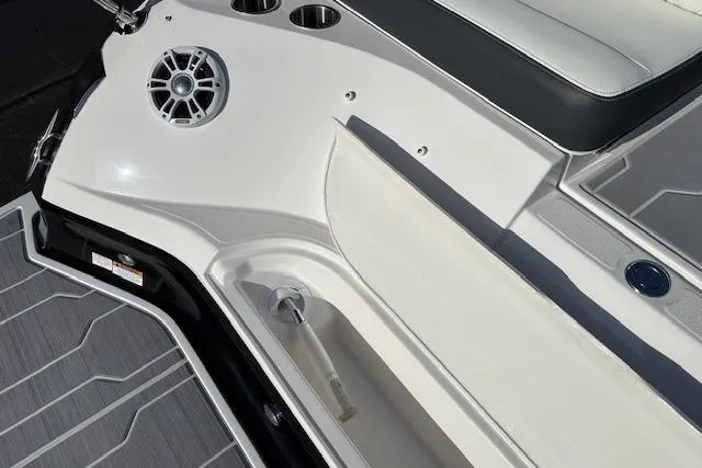 Slide: The Image of 2023 Regal 2800 Bowrider boat interior with speaker and cup holders. - 41