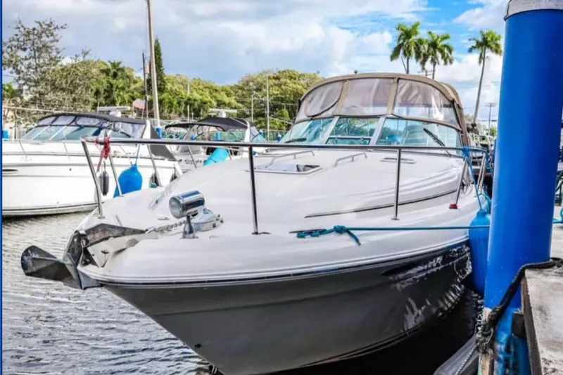 Slide: The Image of 2000 Sea Ray 340 Sundancer docked at marina, surrounded by other boats. - 3