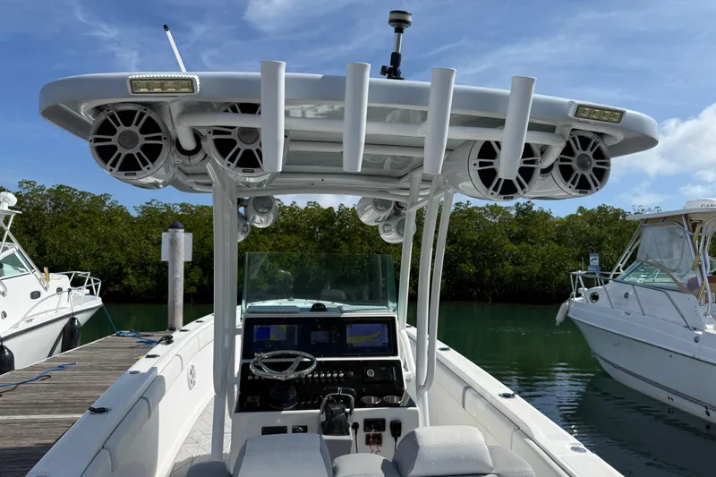 Slide: The Image of 2001 Palmetto Custom 36 boat with advanced navigation system and speakers, docked by lush greenery. - 11